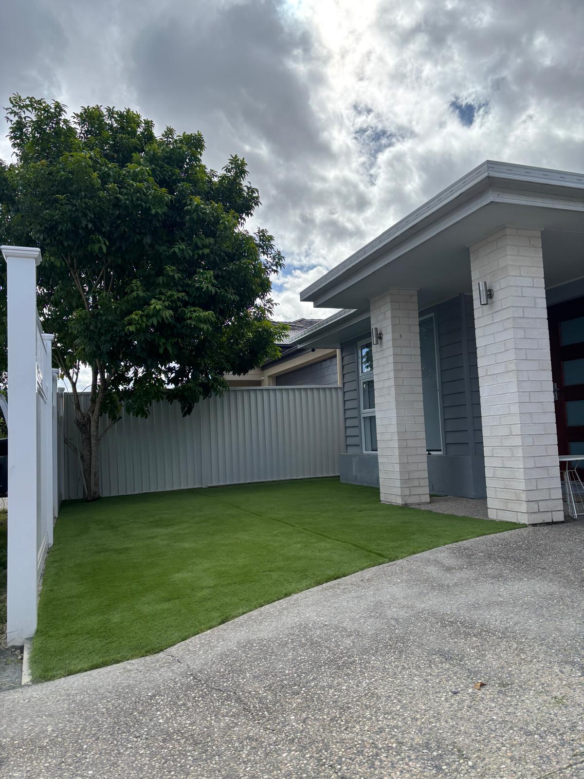 Front yard with synthetic grass and Colourbond fence