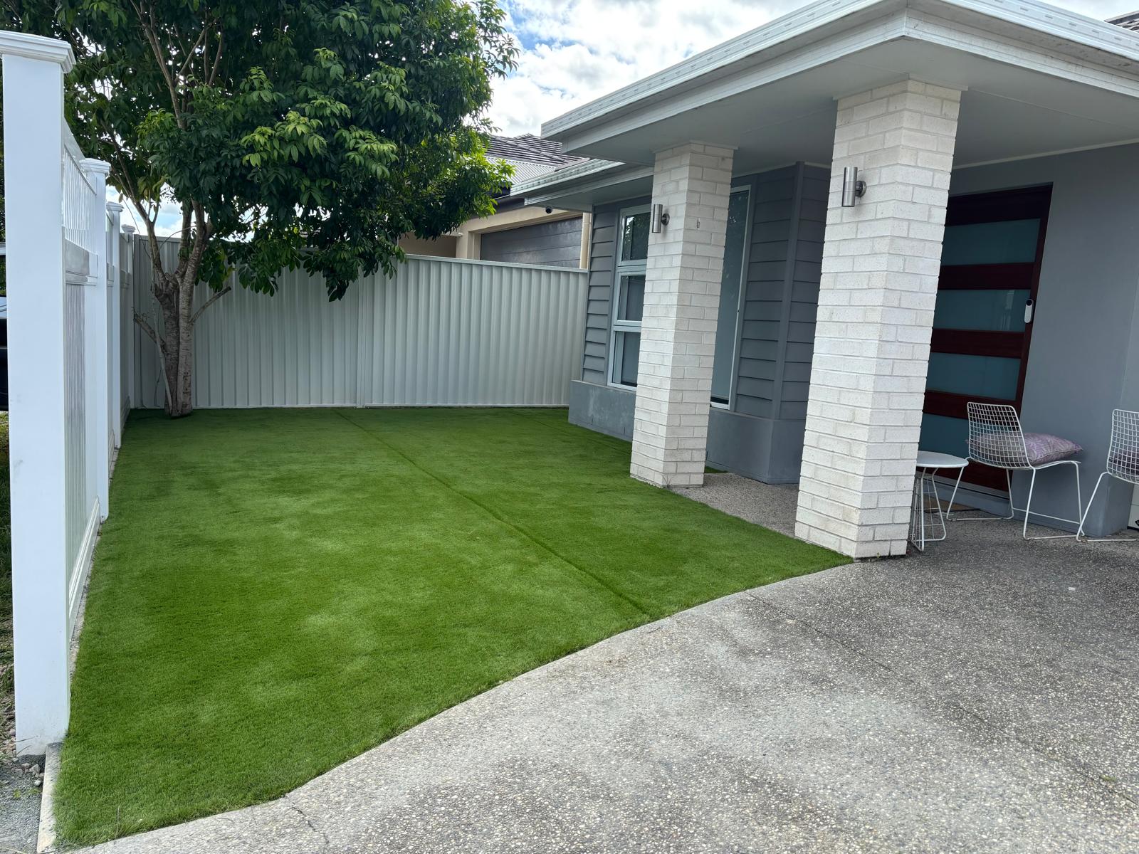 Front yard with new synthetic grass installed.